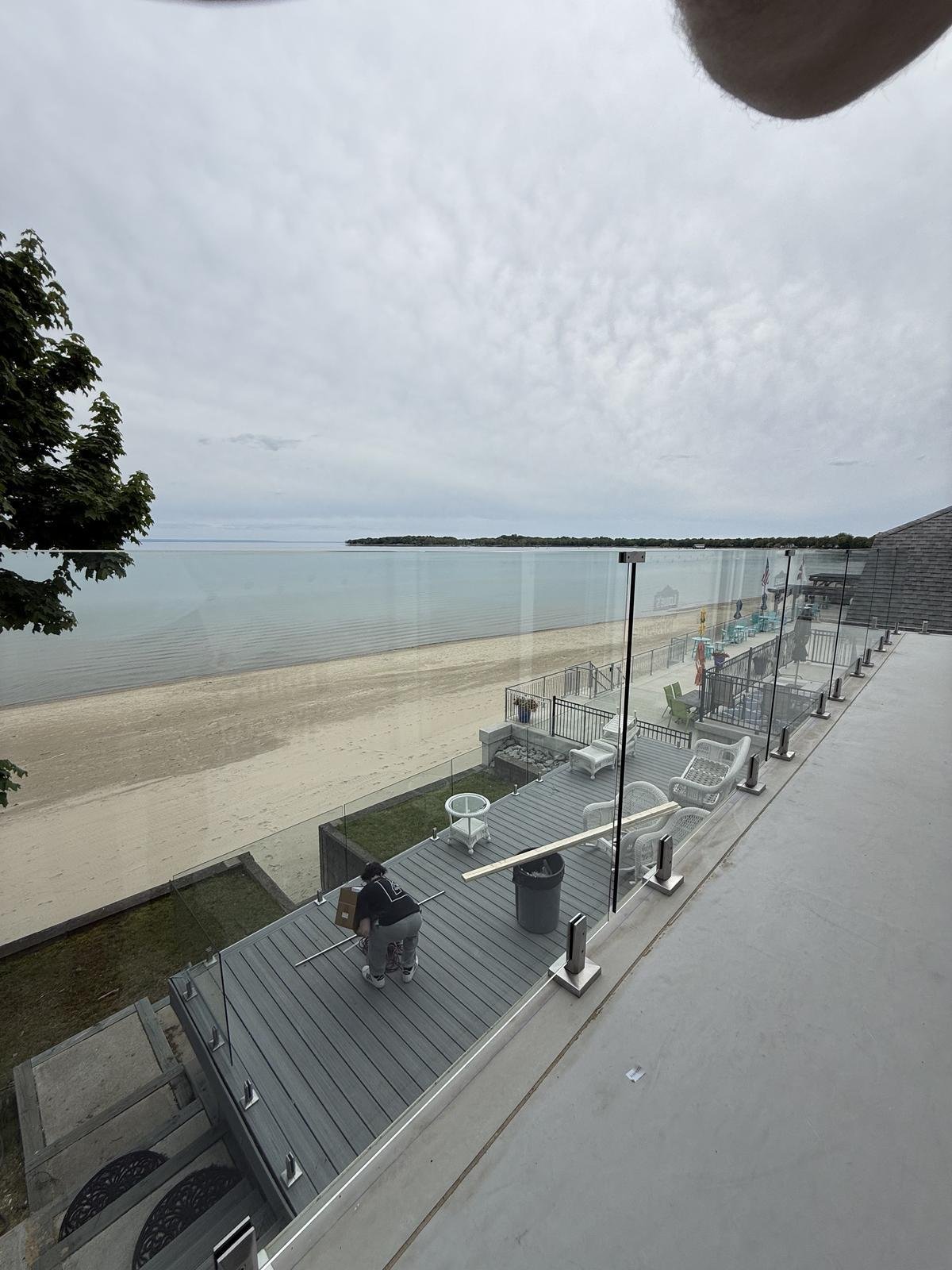 Glass railing on beachfront balcony with ocean view